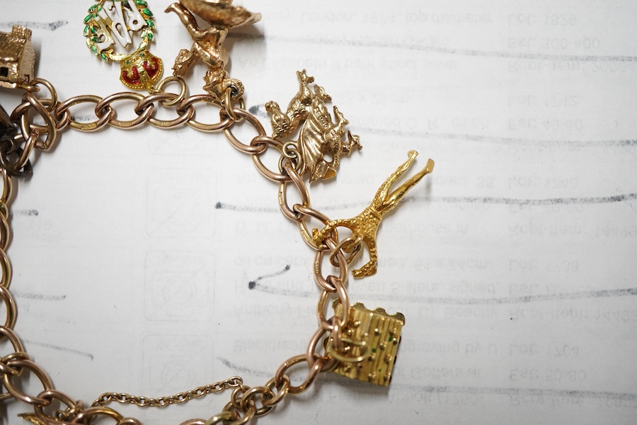 A 9ct gold curb link charm bracelet, hung with ten assorted 9ct gold and yellow metal charms including enamelled R.A.F. charm and a pixie on a toadstool, approximately 14cm, gross weight 31 grams.